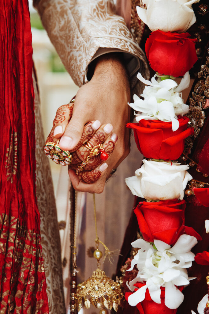 Authentic indian bride and groom's hands holding together in tra