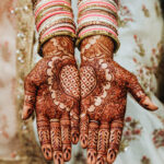 Indian wedding bangles and mehandi henna coloured hands with reflective ornament